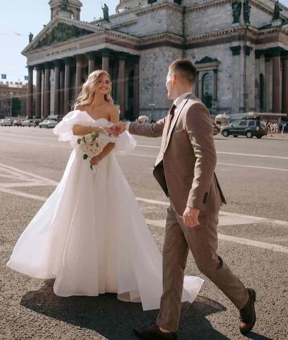 Image 44: Сouple wearing a white gown and a brown suit