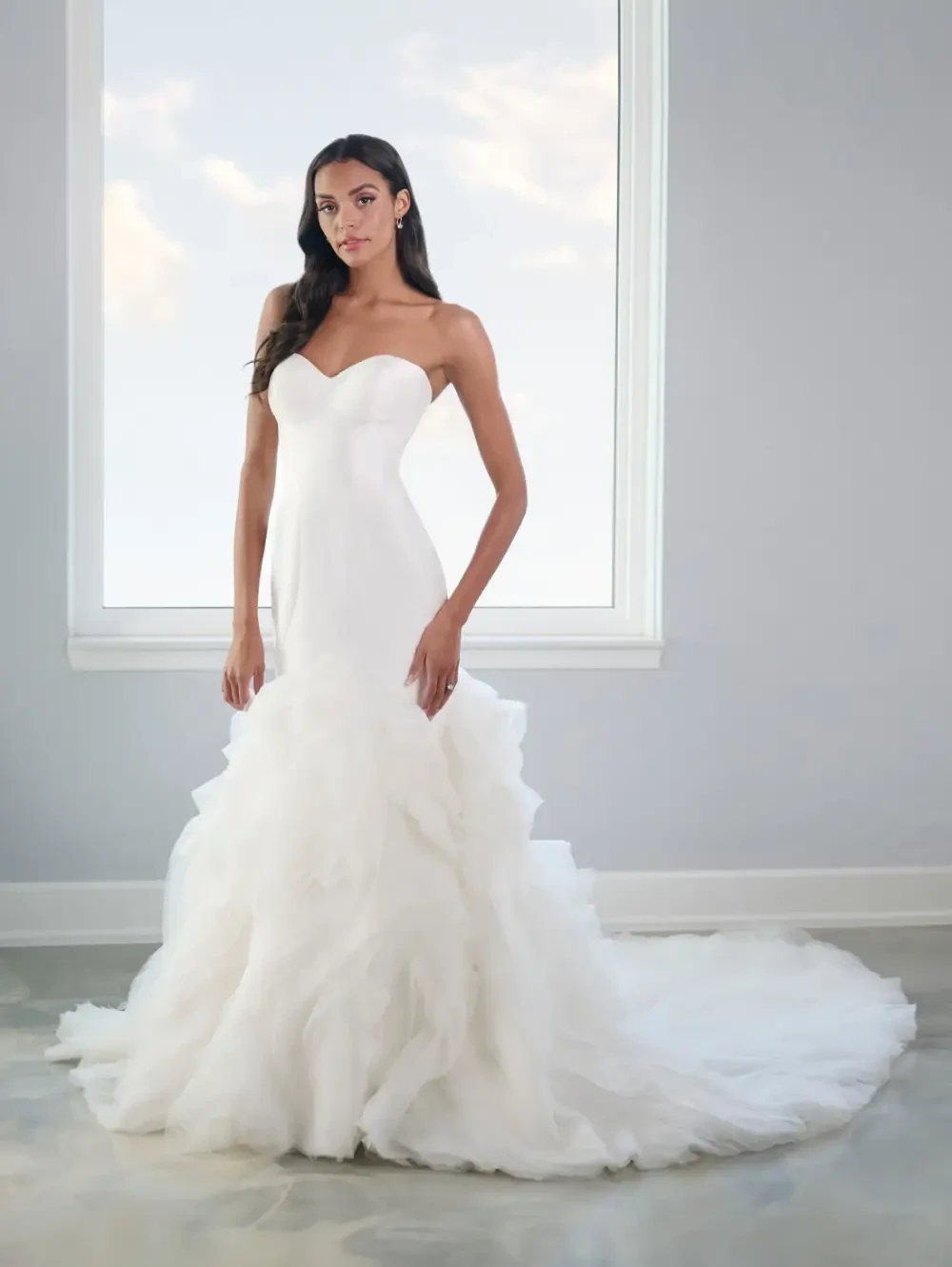Image 29: Model wearing a gown by Nicole Milano